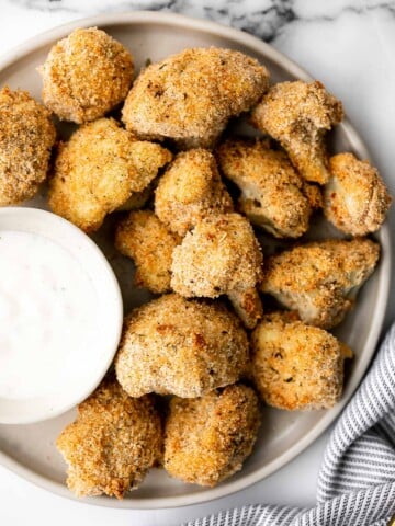 Healthy baked cauliflower nuggets are a vegetarian alternative to chicken nuggets. With parmesan panko breading, these bites are baked until crispy. | aheadofthyme.com