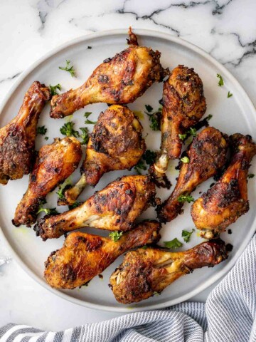 Baked curried chicken drumsticks are an easy to make dinner with quick prep and minimal dishes. They're tender, delicious, and packed with flavour. | aheadofthyme.com
