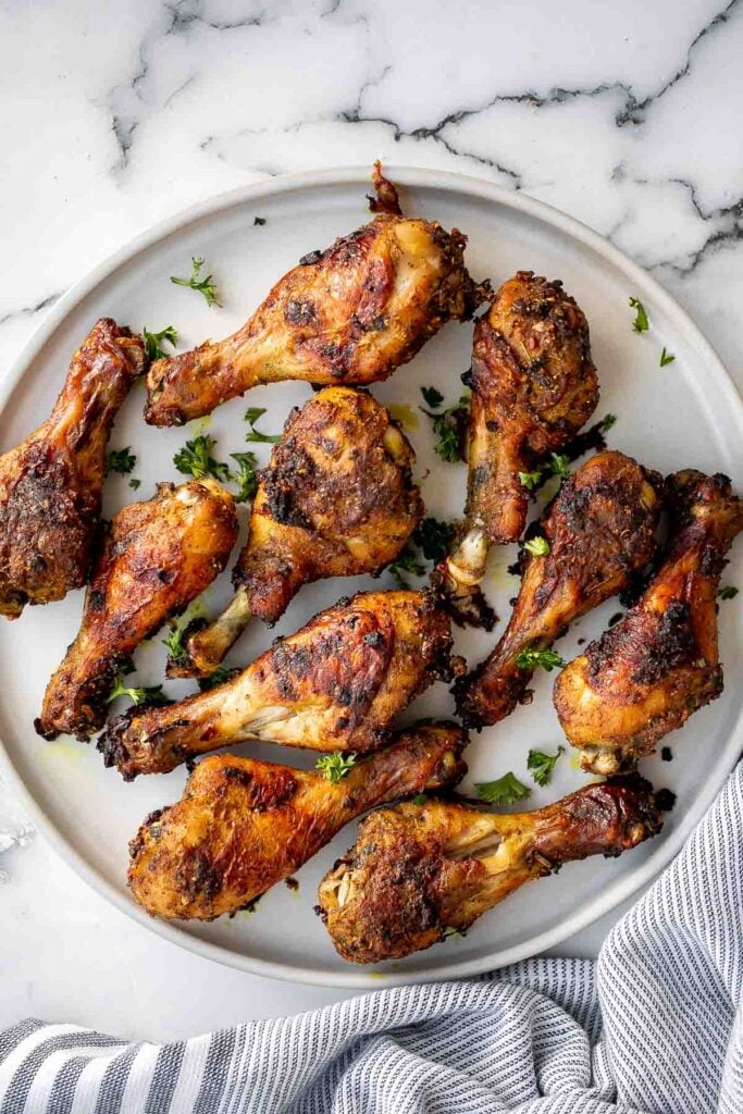 Baked curried chicken drumsticks are an easy to make dinner with quick prep and minimal dishes. They're tender, delicious, and packed with flavour. | aheadofthyme.com