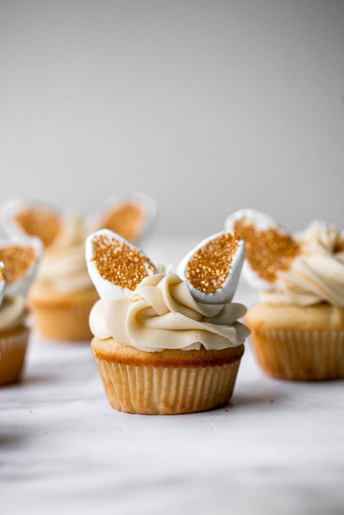 Get festive with these cute bunny ears Easter cupcakes. Buttercream frosting and marshmallows make these vanilla cupcakes extra sweet and delicious. | aheadofthyme.com