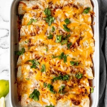 Easy baked chicken enchiladas brings the taste of authentic Mexican food into your kitchen -- saucy, spicy, and savoury. Perfect for a Mexican fiesta. | aheadofthyme.com