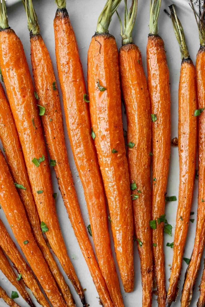 Honey roasted carrots are a sweet, savoury, and salty side dish that pairs well with almost any entree. With these flavours, everyone will want seconds. | aheadofthyme.com