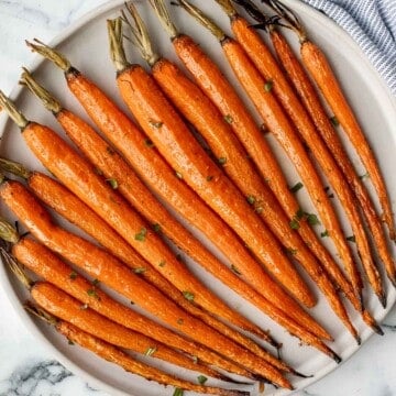 Honey roasted carrots are a sweet, savoury, and salty side dish that pairs well with almost any entree. With these flavours, everyone will want seconds. | aheadofthyme.com