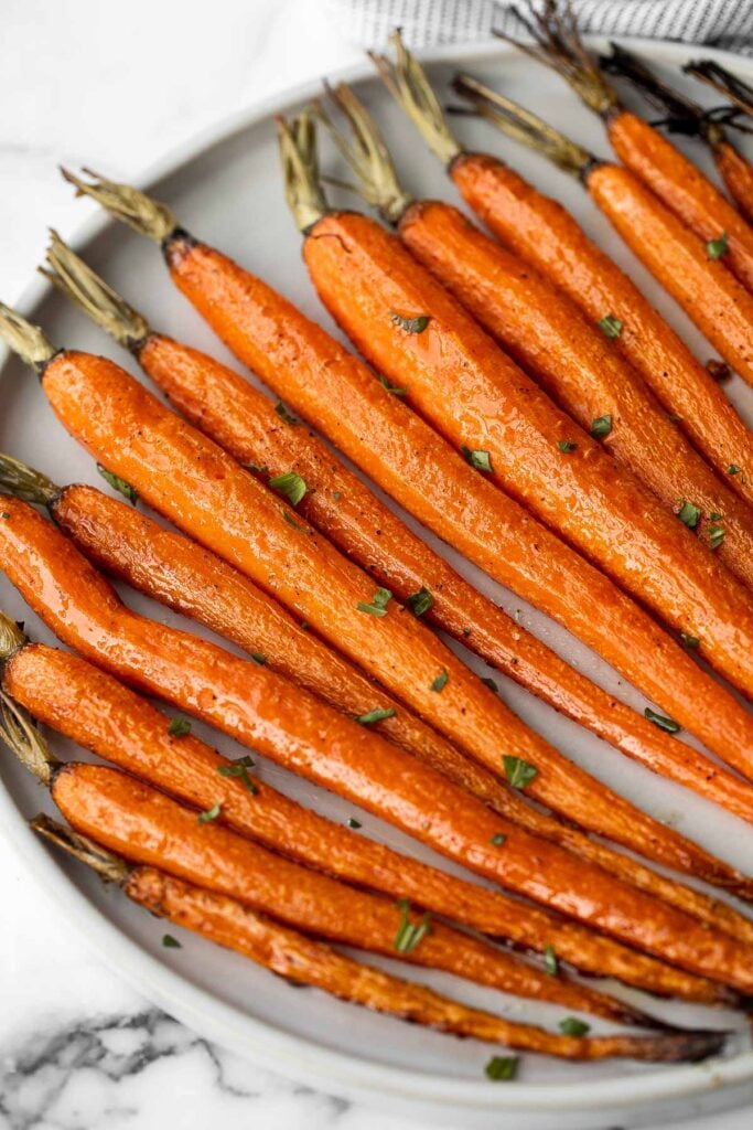Honey roasted carrots are a sweet, savoury, and salty side dish that pairs well with almost any entree. With these flavours, everyone will want seconds. | aheadofthyme.com