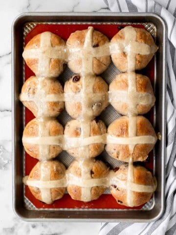 Hot cross buns is a timeless classic Easter bread made with raisins, cinnamon, and a honey glaze. They are perfect for breakfast, a snack or dessert. | aheadofthyme.com