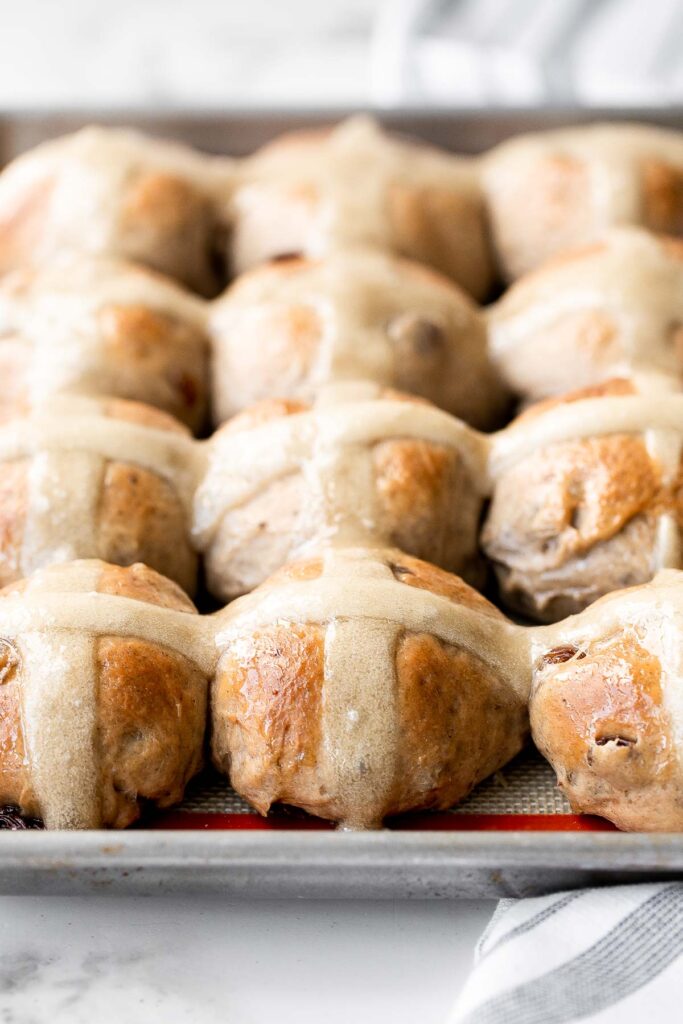 Hot cross buns is a timeless classic Easter bread made with raisins, cinnamon, and a honey glaze. They are perfect for breakfast, a snack or dessert. | aheadofthyme.com