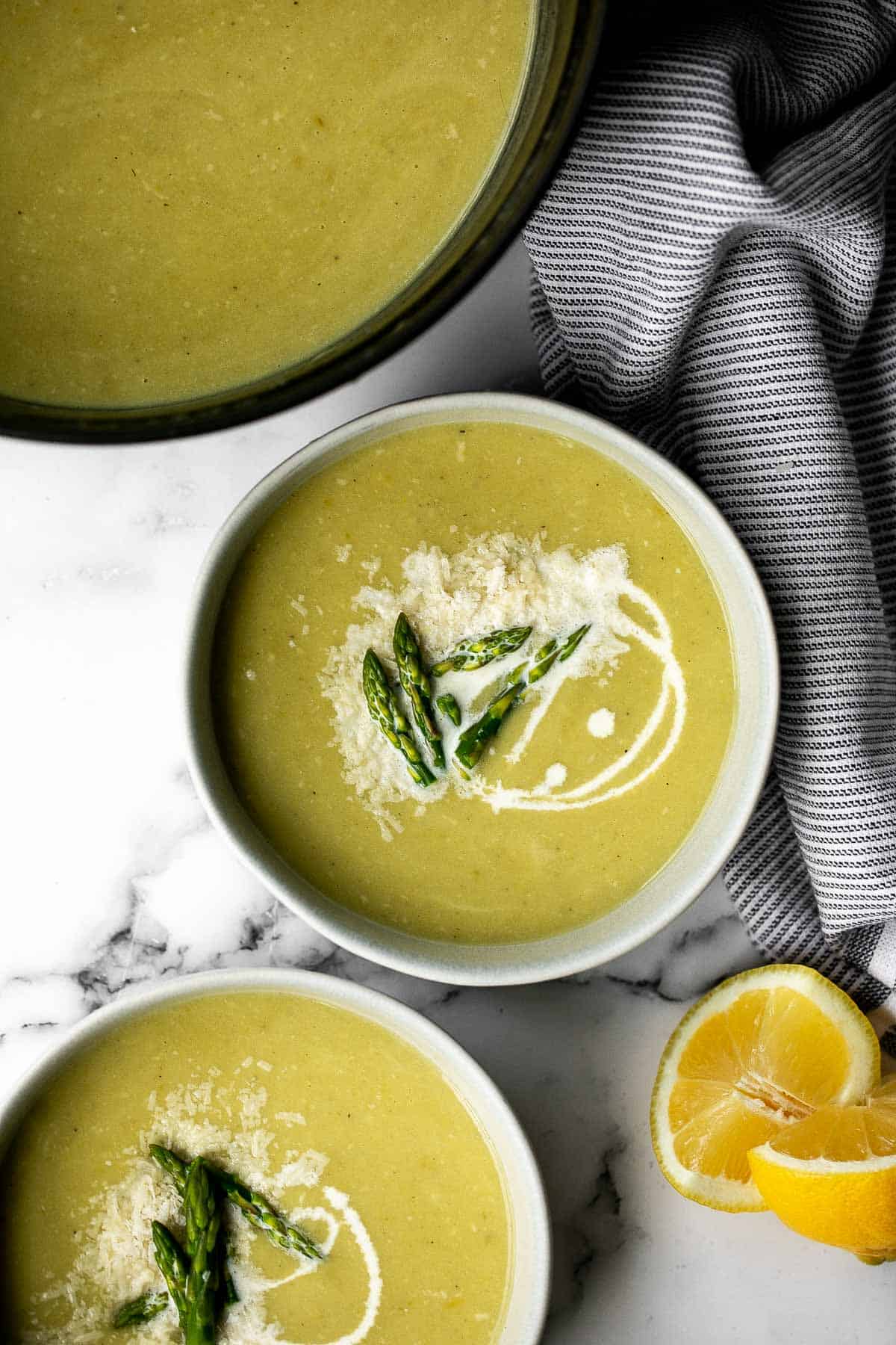 Lemon asparagus soup with parmesan is the perfect spring soup -- smooth, light, fresh, and flavourful. It's customizable and can be served hot or cold. | aheadofthyme.com