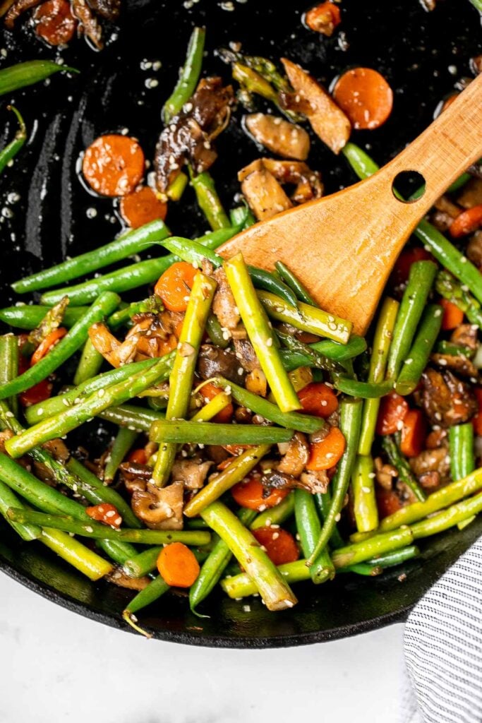 Quick and easy spring vegetable stir fry is made with delicious seasonal vegetables, packed with savoury and salty flavour, and takes 10 minutes to cook. | aheadofthyme.com