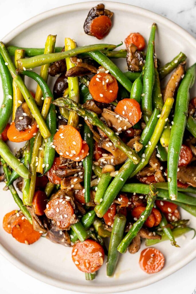 Quick and easy spring vegetable stir fry is made with delicious seasonal vegetables, packed with savoury and salty flavour, and takes 10 minutes to cook. | aheadofthyme.com