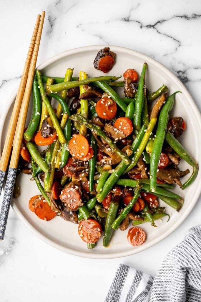 Quick and easy spring vegetable stir fry is made with delicious seasonal vegetables, packed with savoury and salty flavour, and takes 10 minutes to cook. | aheadofthyme.com