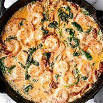 Creamy Tuscan shrimp packed with sun-dried tomatoes, spinach, and garlic, is creamy, rich, and delicious. Make it in just 15 minutes, including prep! | aheadofthyme.com