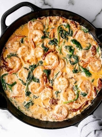 Creamy Tuscan shrimp packed with sun-dried tomatoes, spinach, and garlic, is creamy, rich, and delicious. Make it in just 15 minutes, including prep! | aheadofthyme.com