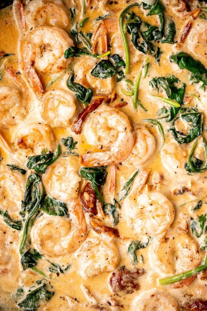 Creamy Tuscan shrimp packed with sun-dried tomatoes, spinach, and garlic, is creamy, rich, and delicious. Make it in just 15 minutes, including prep! | aheadofthyme.com