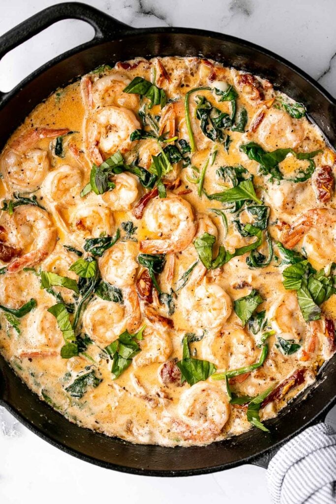 Creamy Tuscan shrimp packed with sun-dried tomatoes, spinach, and garlic, is creamy, rich, and delicious. Make it in just 15 minutes, including prep! | aheadofthyme.com