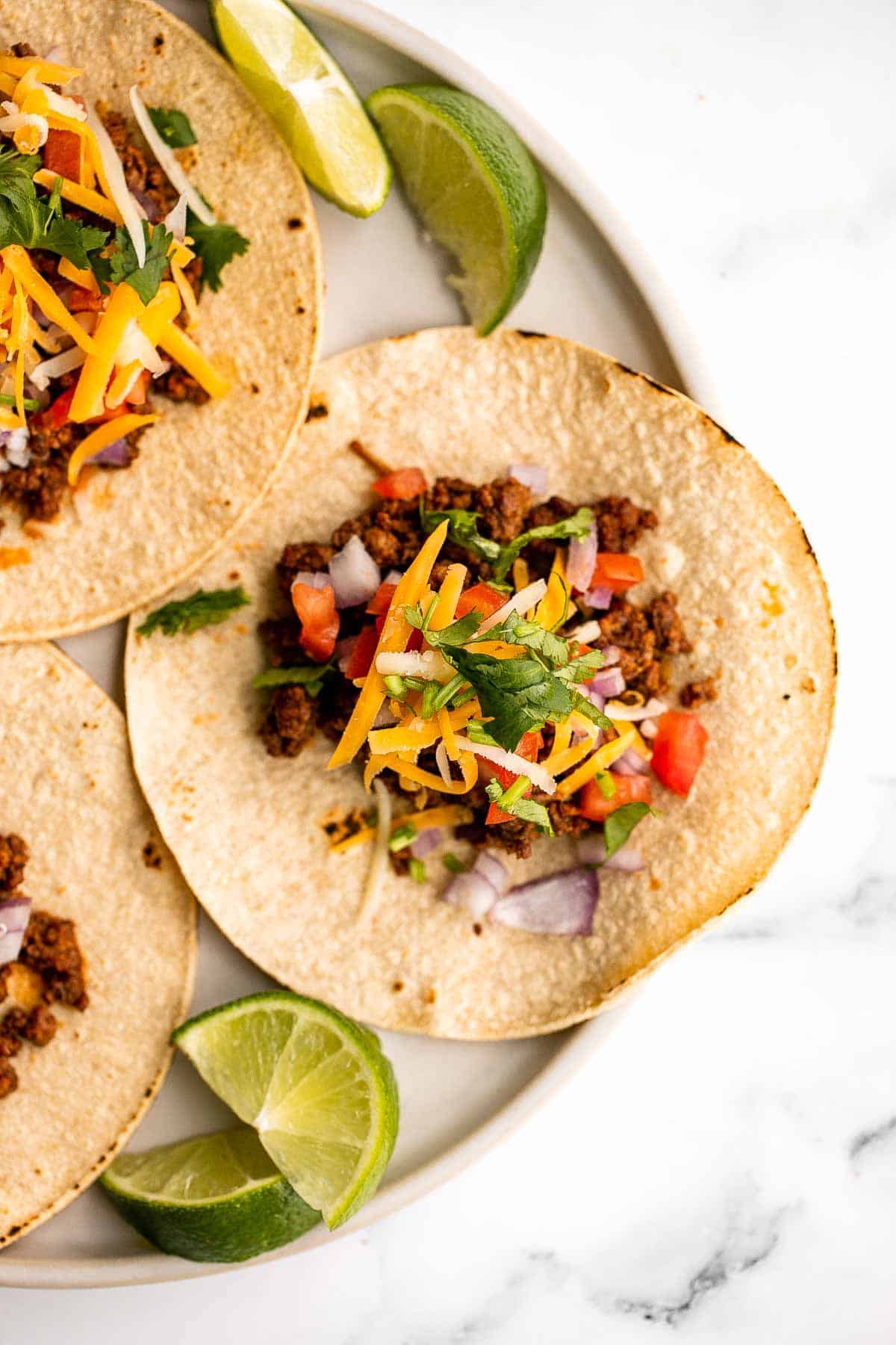 Spice up Taco Tuesday with these delicious, authentic, and easy-to-make Mexican ground beef tacos. Perfect for a quick weeknight dinner or a fiesta! | aheadofthyme.com