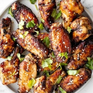 Baked miso garlic chicken wings are crispy, delicious, and easy to make. They're marinated in a savoury Asian marinade, and cooked in the oven or air fryer. | aheadofthyme.com