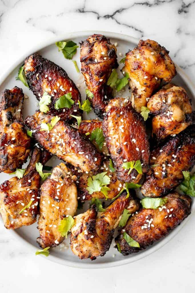 Baked miso garlic chicken wings are crispy, delicious, and easy to make. They're marinated in a savoury Asian marinade, and cooked in the oven or air fryer. | aheadofthyme.com