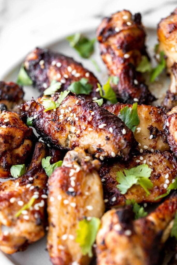 Baked miso garlic chicken wings are crispy, delicious, and easy to make. They're marinated in a savoury Asian marinade, and cooked in the oven or air fryer. | aheadofthyme.com