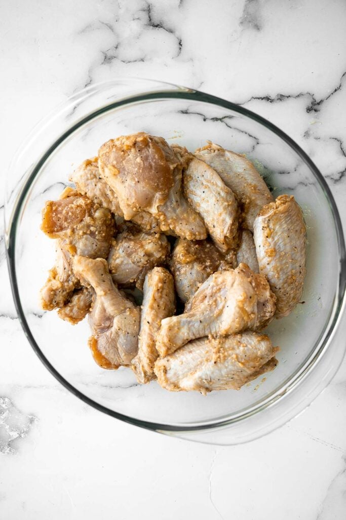 Baked miso garlic chicken wings are crispy, delicious, and easy to make. They're marinated in a savoury Asian marinade, and cooked in the oven or air fryer. | aheadofthyme.com