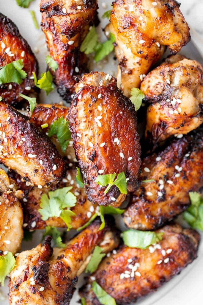 Baked miso garlic chicken wings are crispy, delicious, and easy to make. They're marinated in a savoury Asian marinade, and cooked in the oven or air fryer. | aheadofthyme.com