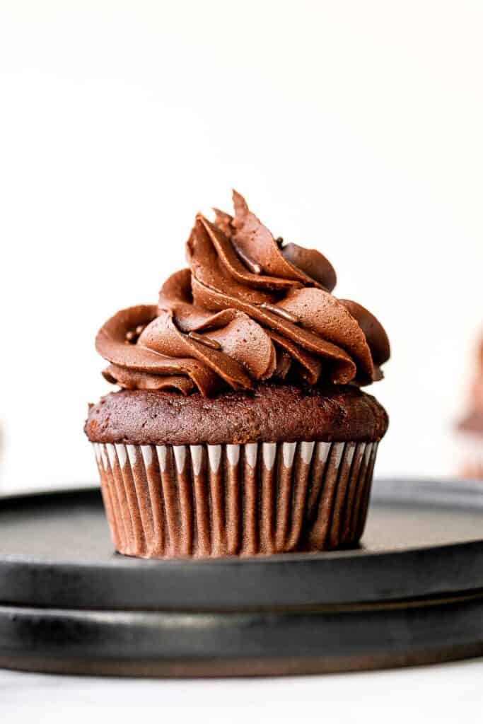Moist chocolate cupcakes topped with chocolate buttercream frosting and sprinkles, are a chocolate triple threat. They're rich, decadent, sweet, and easy. | aheadofthyme.com