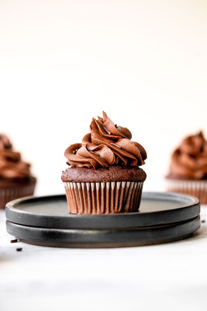 Moist chocolate cupcakes topped with chocolate buttercream frosting and sprinkles, are a chocolate triple threat. They're rich, decadent, sweet, and easy. | aheadofthyme.com