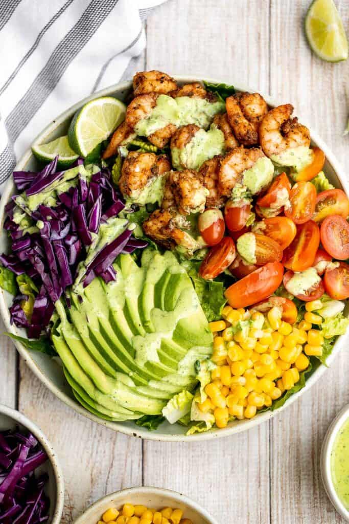 Shrimp taco salad with cilantro lime dressing is flavourful, delicious, and easy to make. It has all the fixings and of shrimp tacos, but without the mess. | aheadofthyme.com