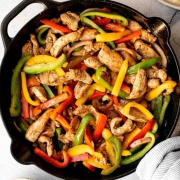 Skillet chicken fajitas are a light, fresh, and sizzling dish bursting with flavour, packed with colorful vegetables, and wrapped in warm tortillas. | aheadofthyme.com