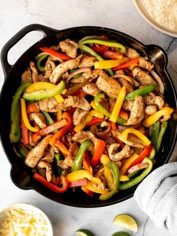 Skillet chicken fajitas are a light, fresh, and sizzling dish bursting with flavour, packed with colorful vegetables, and wrapped in warm tortillas. | aheadofthyme.com