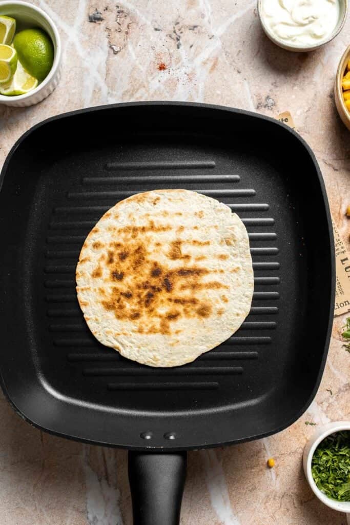 Soft tortilla heated until lightly charred.