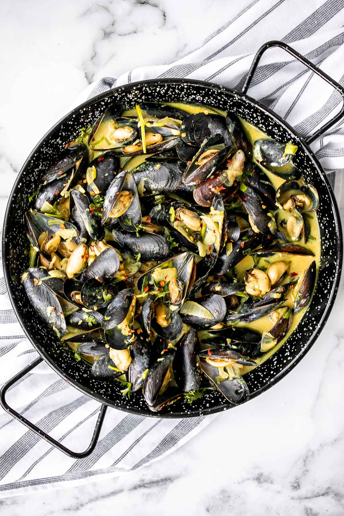 Yellow curry mussels are the epitome of delicious seafood - creamy, spicy, and savory. This flavourful one pot dish is quick + easy to make in 25 minutes. | aheadofthyme.com