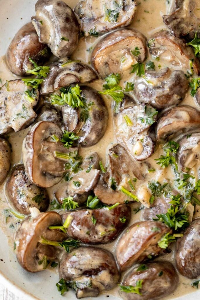 Creamy garlic mushrooms are a simple, delicious, and easy side dish. This comforting family favorite that is quick and easy to make in just 15 minutes. | aheadofthyme.com