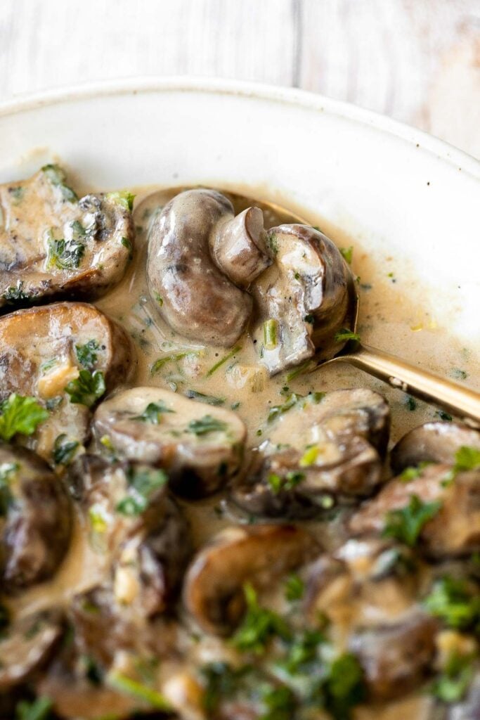 Creamy garlic mushrooms are a simple, delicious, and easy side dish. This comforting family favorite that is quick and easy to make in just 15 minutes. | aheadofthyme.com