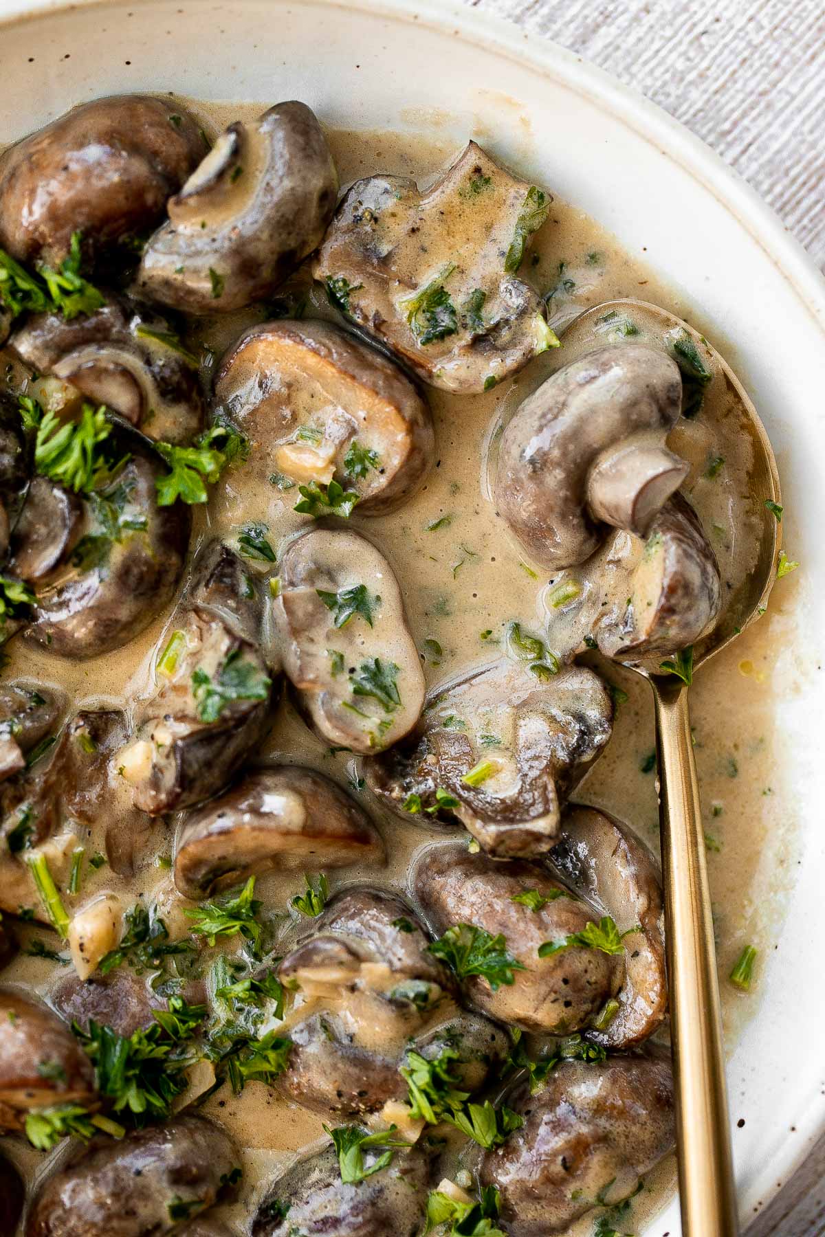 Creamy garlic mushrooms are a simple, delicious, and easy side dish. This comforting family favorite that is quick and easy to make in just 15 minutes. | aheadofthyme.com