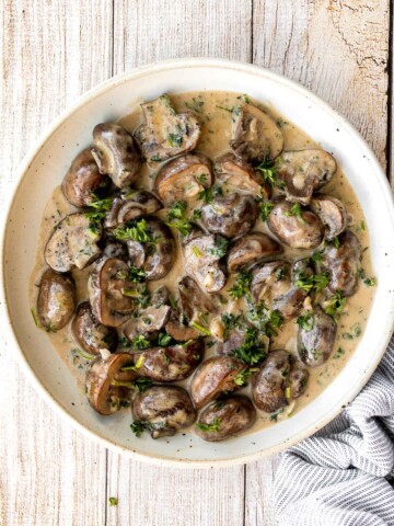 Creamy garlic mushrooms are a simple, delicious, and easy side dish. This comforting family favorite that is quick and easy to make in just 15 minutes. | aheadofthyme.com