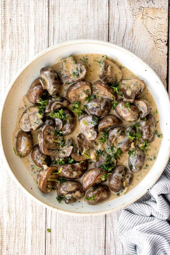 Creamy garlic mushrooms are a simple, delicious, and easy side dish. This comforting family favorite that is quick and easy to make in just 15 minutes. | aheadofthyme.com