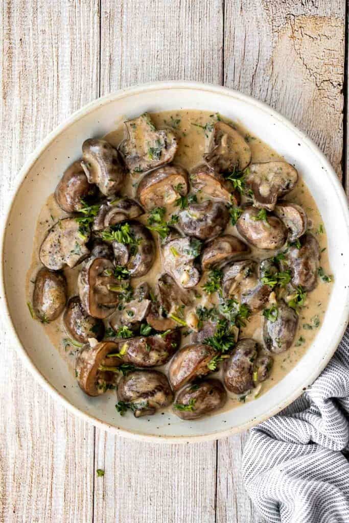 Creamy Garlic Mushrooms with Parmesan are rich, buttery, and ready in 15 minutes. A quick one-pan side dish or pasta topper! | aheadofthyme.com