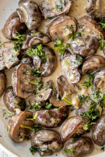 Creamy Garlic Mushrooms with Parmesan are rich, buttery, and ready in 15 minutes. A quick one-pan side dish or pasta topper! | aheadofthyme.com