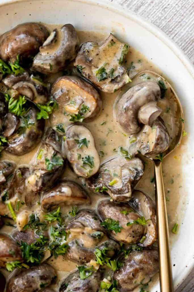 Creamy Garlic Mushrooms with Parmesan are rich, buttery, and ready in 15 minutes. A quick one-pan side dish or pasta topper! | aheadofthyme.com
