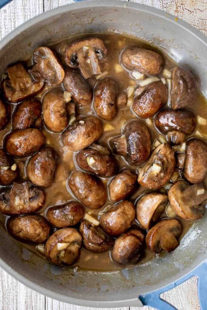 Creamy Garlic Mushrooms with Parmesan are rich, buttery, and ready in 15 minutes. A quick one-pan side dish or pasta topper! | aheadofthyme.com