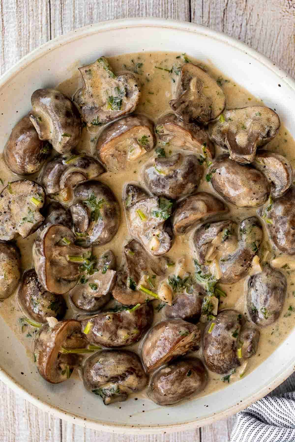 Creamy Garlic Mushrooms with Parmesan are rich, buttery, and ready in 15 minutes. A quick one-pan side dish or pasta topper! | aheadofthyme.com