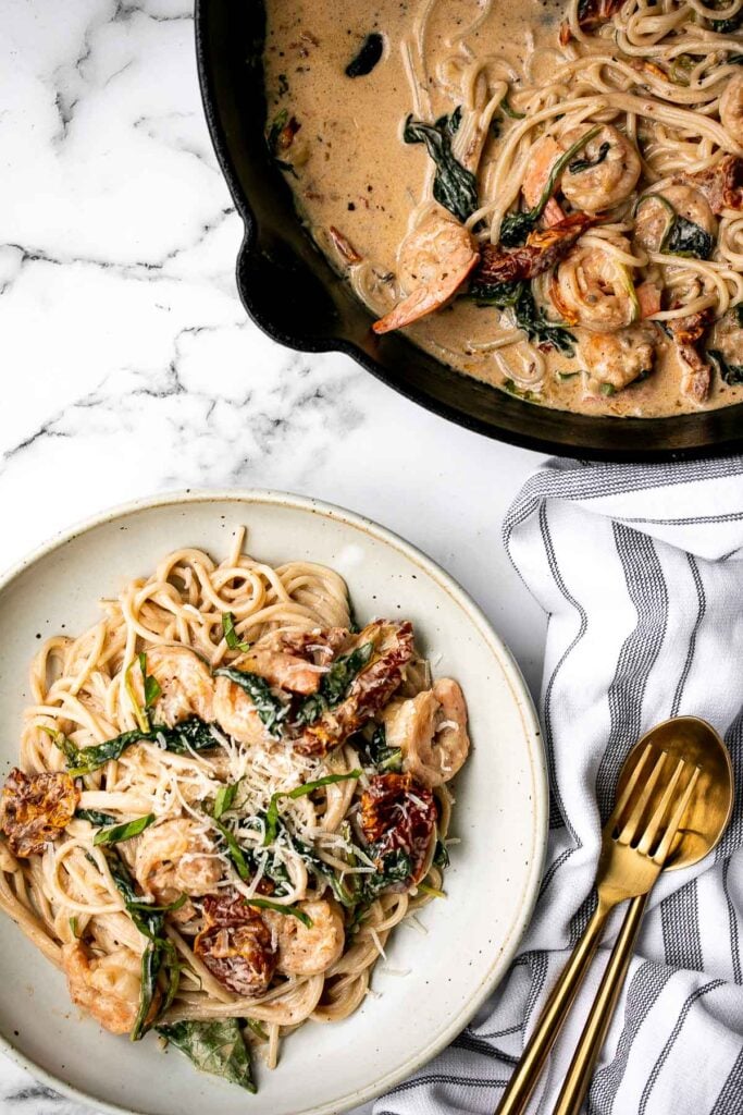 Creamy shrimp pasta with sun-dried tomatoes is a delicious, quick and easy meal that takes just 20 minutes to prep and make. The perfect weeknight dinner. | aheadofthyme.com