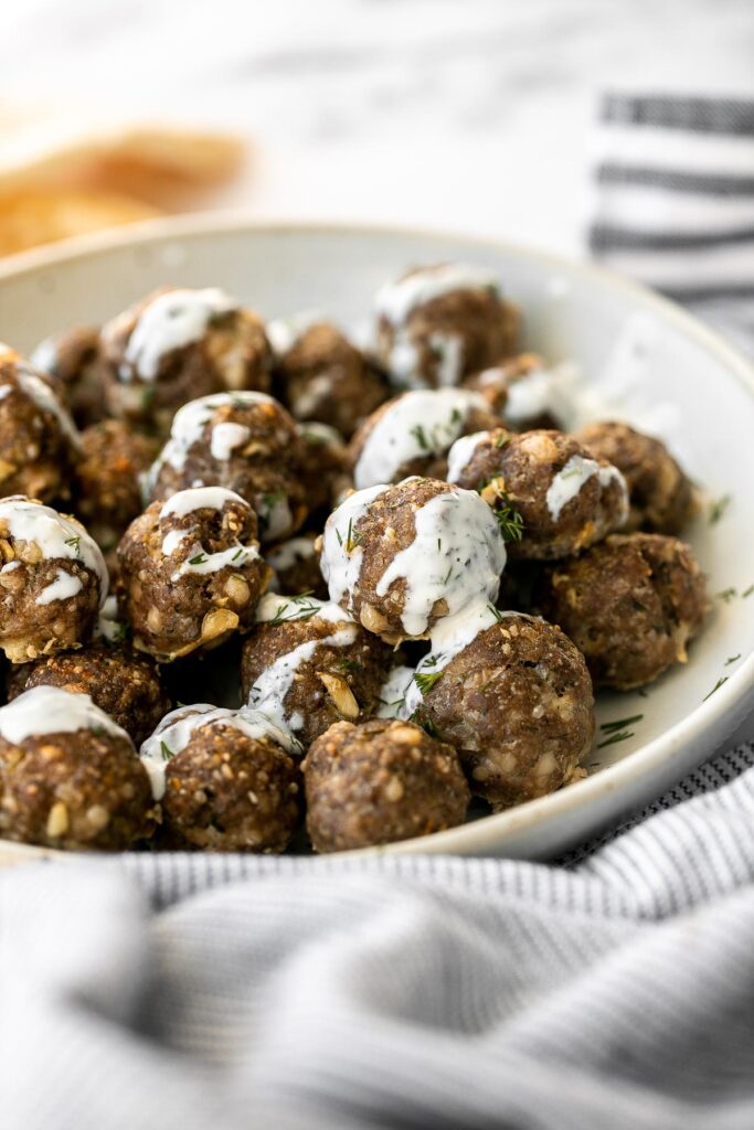 Baked Greek meatballs are juicy, tender, flavorful, and delicious. They are quick and easy to make in 30 minutes, and freezer-friendly. Serve with tzatziki. | aheadofthyme.com