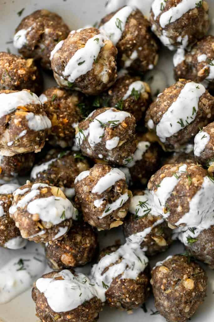 Baked Greek meatballs are juicy, tender, flavorful, and delicious. They are quick and easy to make in 30 minutes, and freezer-friendly. Serve with tzatziki. | aheadofthyme.com