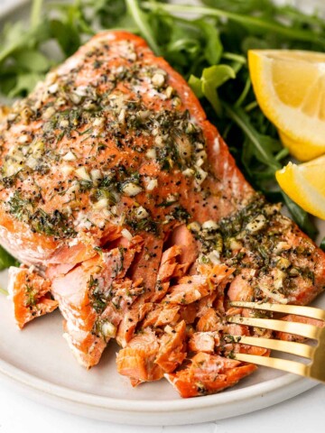 Greek salmon is delicious, flaky, and tender. This healthy oven-baked salmon is packed with Mediterranean flavors and is ready in just 20 minutes. | aheadofthyme.com