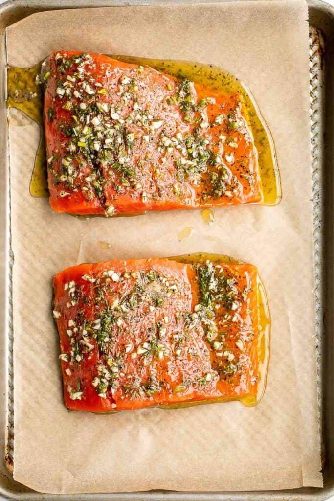 Greek salmon is delicious, flaky, and tender. This healthy oven-baked salmon is packed with Mediterranean flavors and is ready in just 20 minutes. | aheadofthyme.com