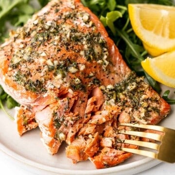 Greek salmon is delicious, flaky, and tender. This healthy oven-baked salmon is packed with Mediterranean flavors and is ready in just 20 minutes. | aheadofthyme.com