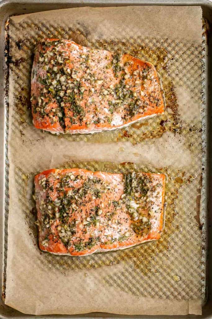 Greek salmon is delicious, flaky, and tender. This healthy oven-baked salmon is packed with Mediterranean flavors and is ready in just 20 minutes. | aheadofthyme.com