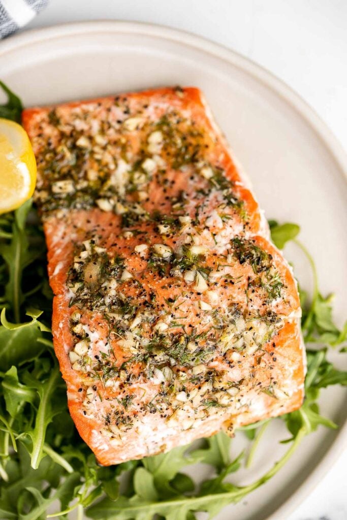 Greek salmon is delicious, flaky, and tender. This healthy oven-baked salmon is packed with Mediterranean flavors and is ready in just 20 minutes. | aheadofthyme.com