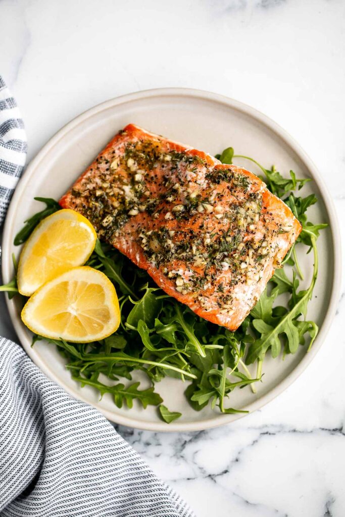 Greek salmon is delicious, flaky, and tender. This healthy oven-baked salmon is packed with Mediterranean flavors and is ready in just 20 minutes. | aheadofthyme.com